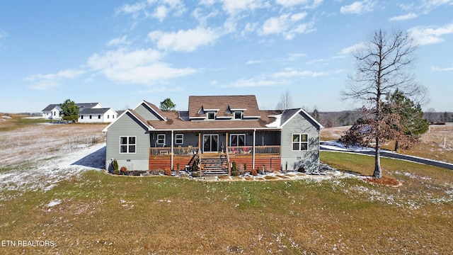 view of front of property featuring covered porch and a front lawn