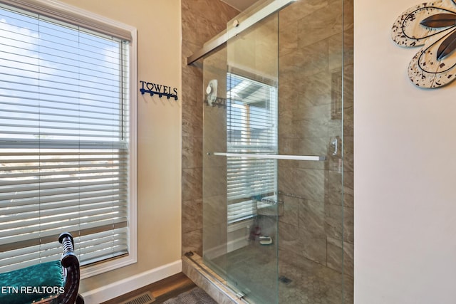 bathroom featuring wood-type flooring and walk in shower