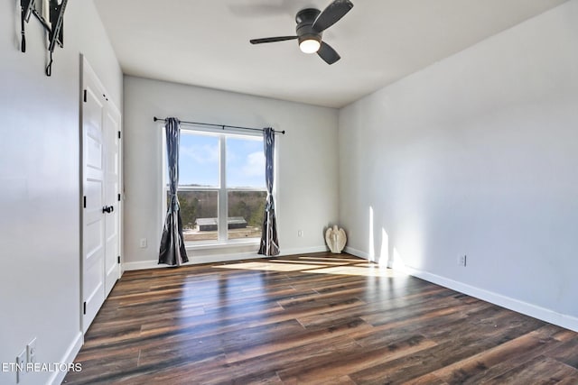 spare room with ceiling fan and dark hardwood / wood-style floors