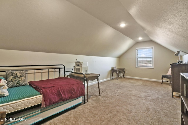 carpeted bedroom featuring lofted ceiling and a textured ceiling