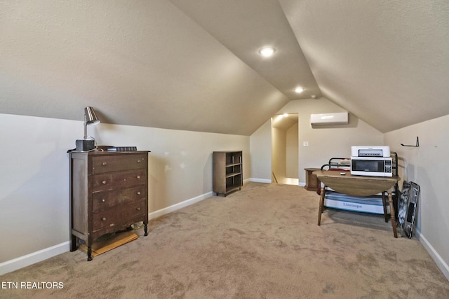 interior space featuring carpet, a textured ceiling, an AC wall unit, and lofted ceiling