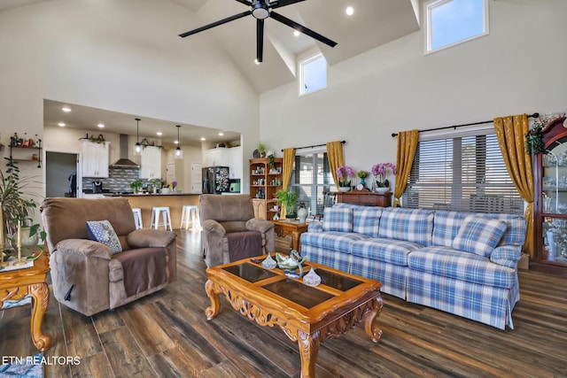 living room with dark hardwood / wood-style flooring, high vaulted ceiling, and ceiling fan