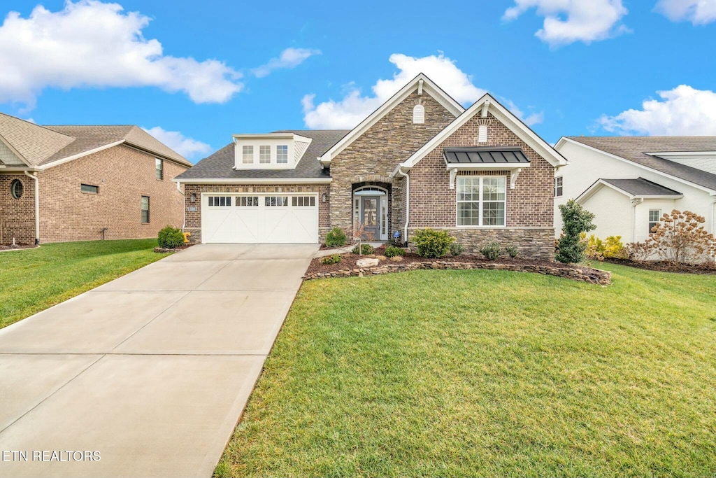 view of front of home featuring a garage and a front lawn