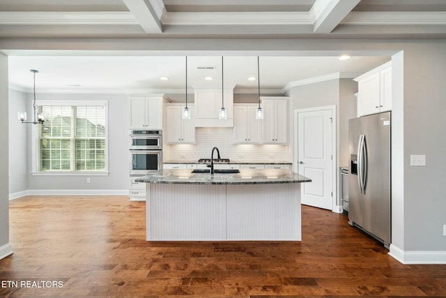 330 Kendall Hunt St, Knoxville, TN 37934 - kitchen with appliances with stainless steel finishes, dark stone counters, beam ceiling, a center island with sink, and white cabinets