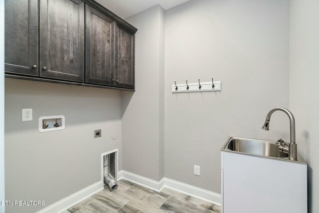 330 Kendall Hunt St, Knoxville, TN 37934 - laundry room featuring electric dryer hookup, hookup for a washing machine, sink, and cabinets