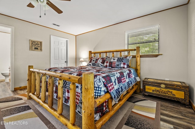 bedroom with ensuite bath, ceiling fan, and hardwood / wood-style flooring