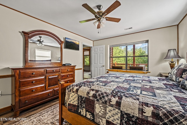 bedroom with hardwood / wood-style flooring, ceiling fan, and ornamental molding