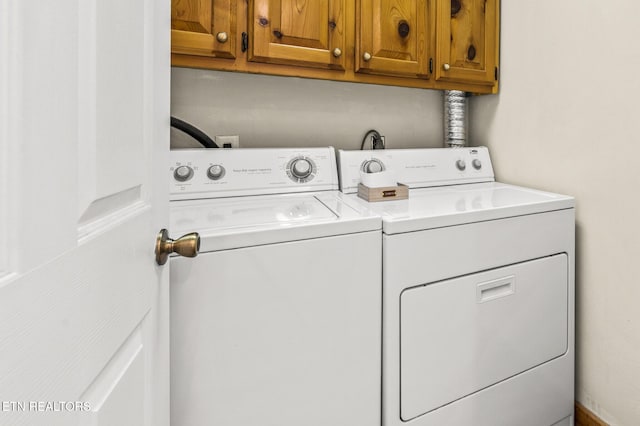 laundry room with cabinets and washer and clothes dryer