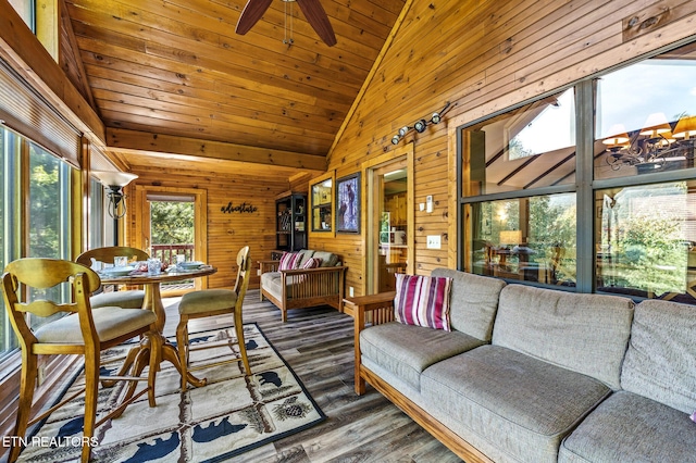 sunroom / solarium featuring vaulted ceiling, ceiling fan, and wooden ceiling