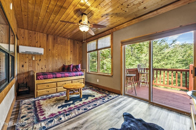 bedroom featuring access to exterior, a wall unit AC, hardwood / wood-style flooring, wooden ceiling, and wood walls