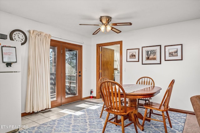 tiled dining room with ceiling fan