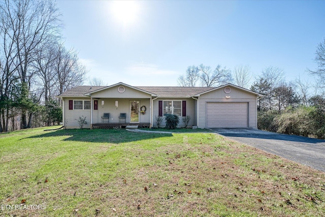 ranch-style home with a front yard, a porch, and a garage