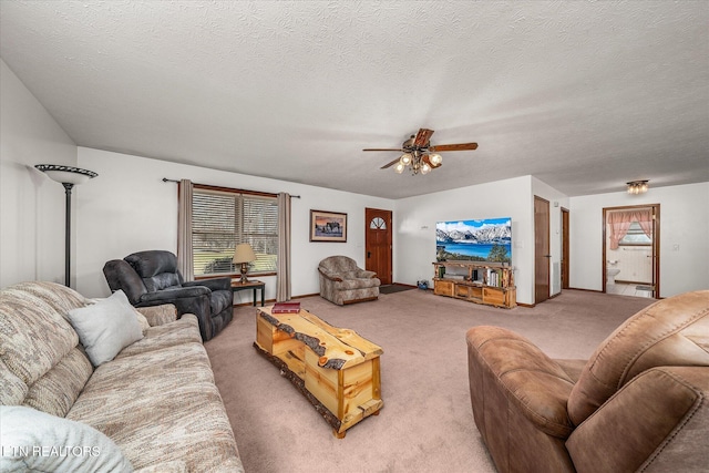 living room with ceiling fan, carpet, and a textured ceiling