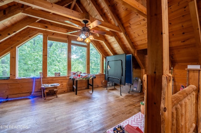 bonus room with hardwood / wood-style floors, wooden ceiling, wooden walls, ceiling fan, and vaulted ceiling with beams