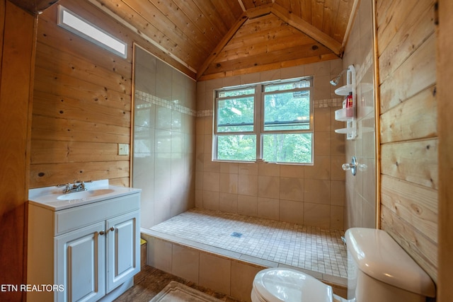 bathroom featuring a tile shower, wood walls, wood ceiling, and lofted ceiling