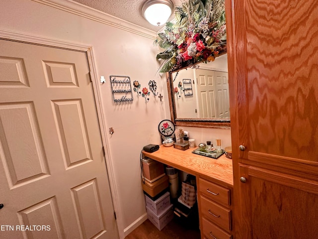 office area with ornamental molding and a textured ceiling