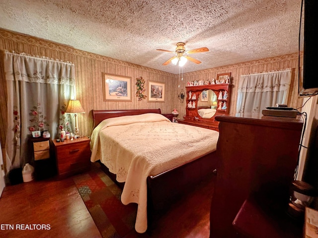 bedroom featuring ceiling fan, dark wood-type flooring, and a textured ceiling