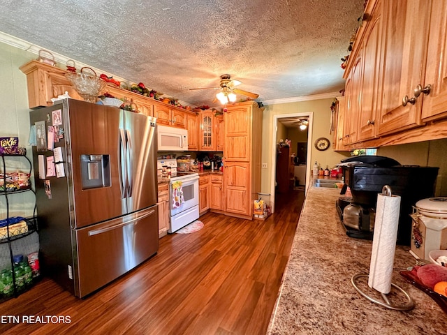 kitchen featuring a textured ceiling, dark hardwood / wood-style floors, white appliances, and crown molding