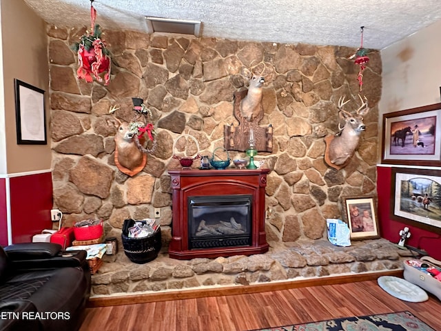 room details featuring hardwood / wood-style floors and a textured ceiling