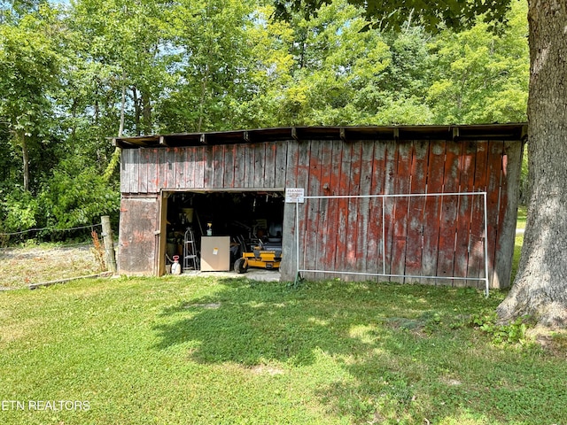 view of outbuilding featuring a yard