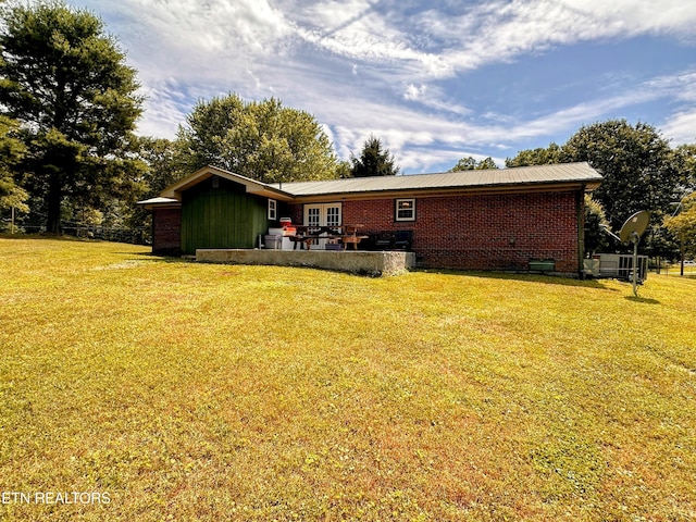 back of house with a lawn