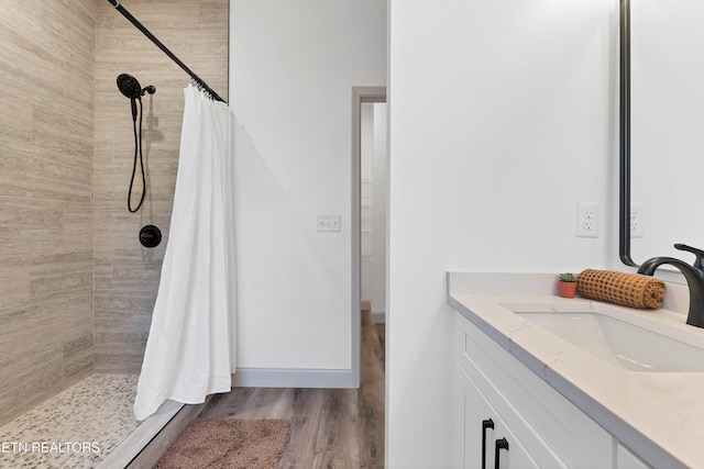 bathroom with vanity, hardwood / wood-style flooring, and curtained shower