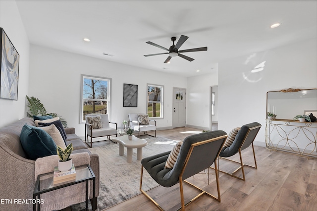 living room featuring ceiling fan and light wood-type flooring