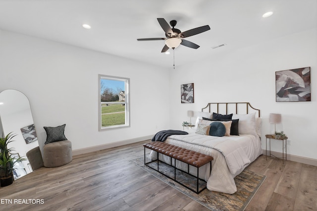 bedroom featuring hardwood / wood-style floors and ceiling fan