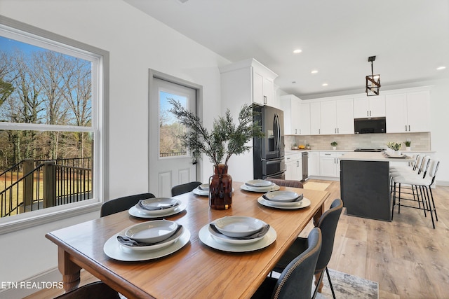 dining space featuring plenty of natural light and light wood-type flooring