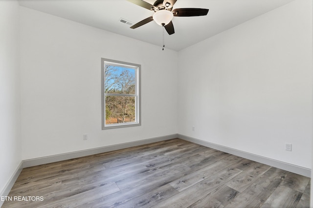 empty room with ceiling fan and light wood-type flooring