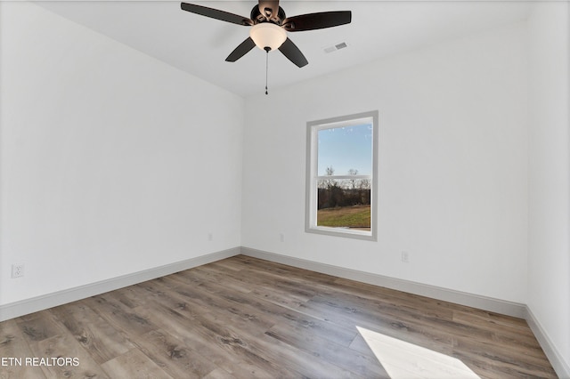 spare room featuring ceiling fan and light hardwood / wood-style floors