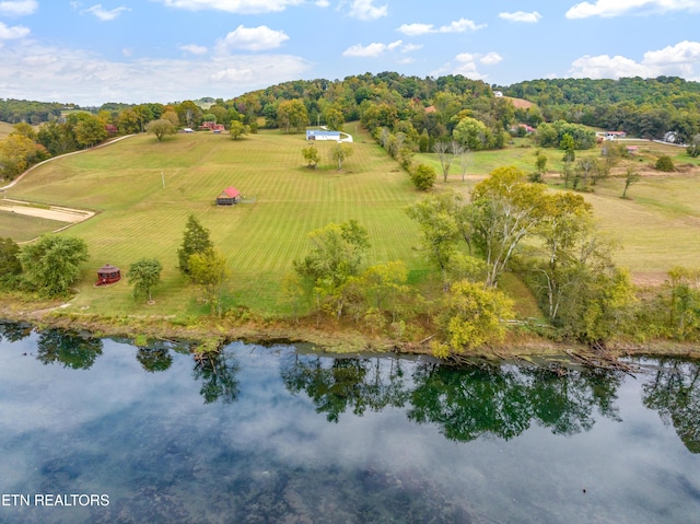 drone / aerial view featuring a rural view and a water view