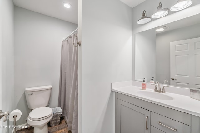 bathroom featuring vanity and toilet