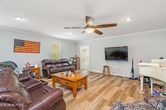 living room with crown molding, ceiling fan, and light wood-type flooring