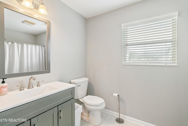 bathroom featuring tile patterned floors, vanity, and toilet