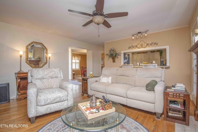 living room with ceiling fan and light hardwood / wood-style floors