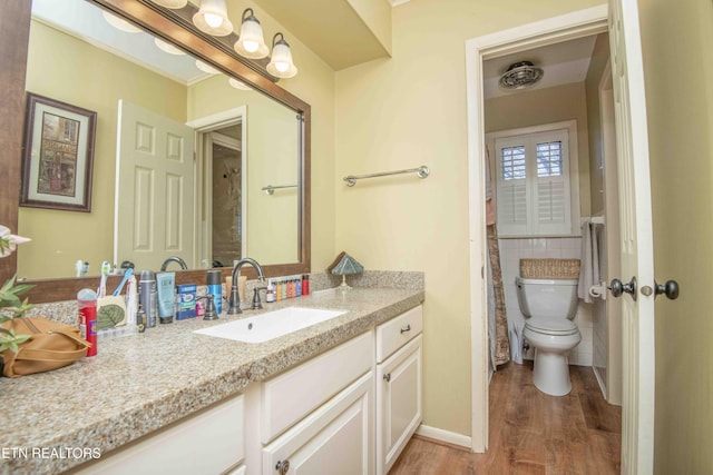 bathroom with hardwood / wood-style floors, vanity, toilet, and tile walls