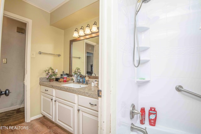 bathroom featuring hardwood / wood-style flooring, vanity, and tub / shower combination