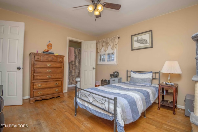 bedroom featuring light hardwood / wood-style floors, ensuite bath, and ceiling fan