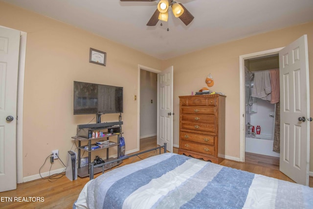 bedroom with ceiling fan, light wood-type flooring, a spacious closet, and a closet