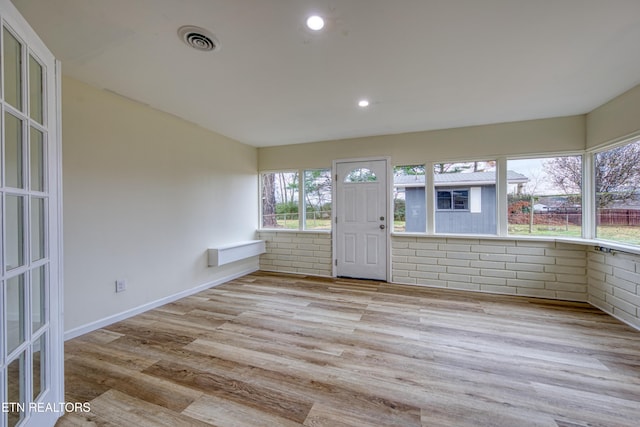 unfurnished sunroom with a wealth of natural light