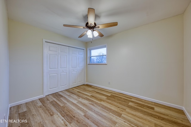 unfurnished bedroom with ceiling fan, light hardwood / wood-style floors, and a closet