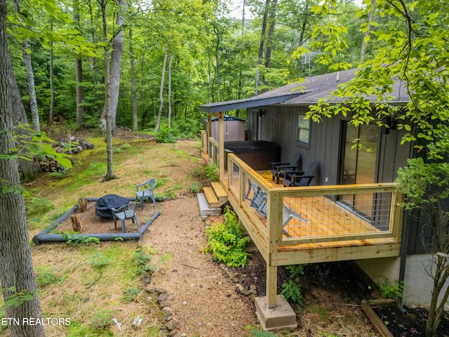 view of yard featuring a jacuzzi and a deck