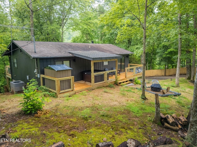 back of property featuring cooling unit and a deck