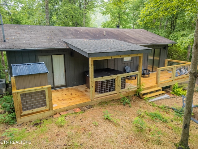 rear view of property featuring a deck