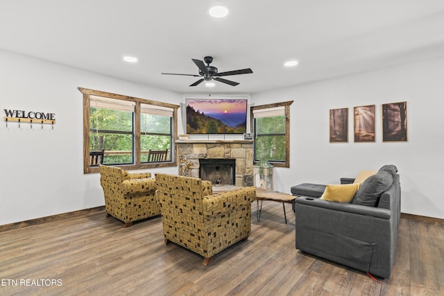 living room featuring a fireplace, ceiling fan, and hardwood / wood-style floors