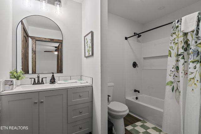 full bathroom with hardwood / wood-style flooring, vanity, toilet, and shower / tub combo with curtain