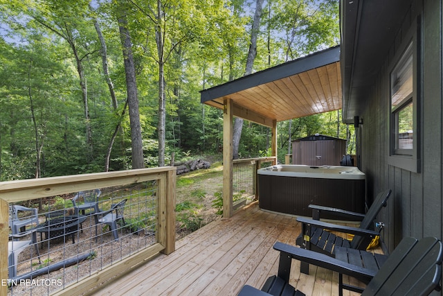 wooden deck featuring a hot tub