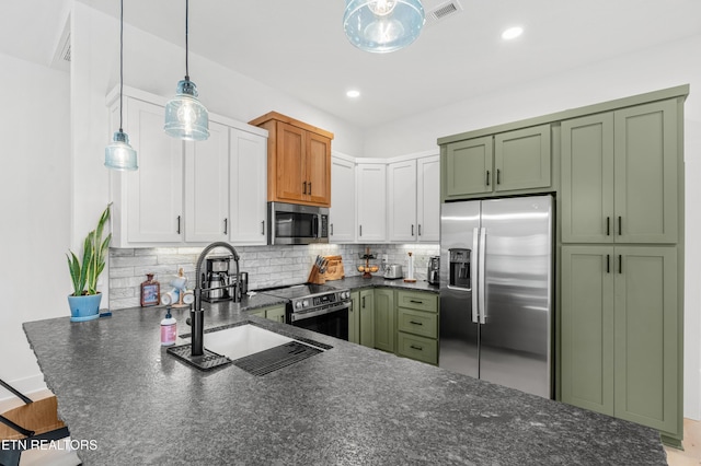 kitchen with white cabinetry, sink, backsplash, decorative light fixtures, and appliances with stainless steel finishes