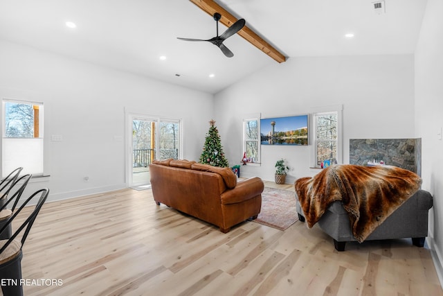 living room with vaulted ceiling with beams, ceiling fan, and light hardwood / wood-style floors